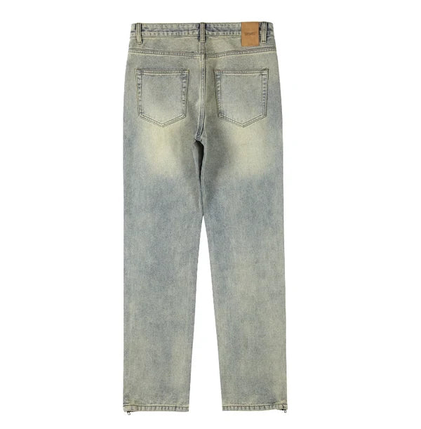 Back view of light-wash blue denim jeans with a faded yellowish tint, showing the back pockets and waistband on a white background.