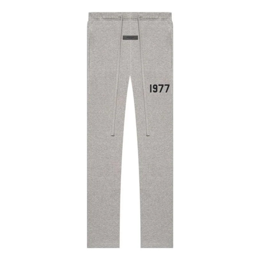 Gray essentials sweatpants with '1977' printed on a white background