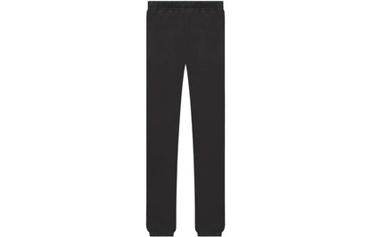 Back of Black essentials sweatpants with '1977' printed on the front against a white background