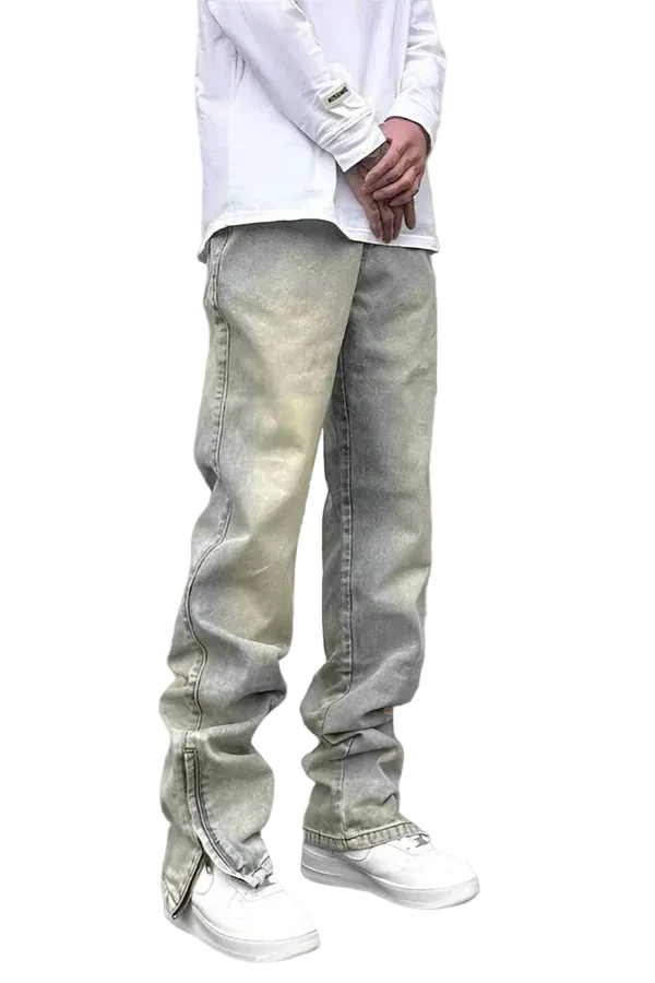 Person wearing light-colored jeans and a white shirt on a gray background