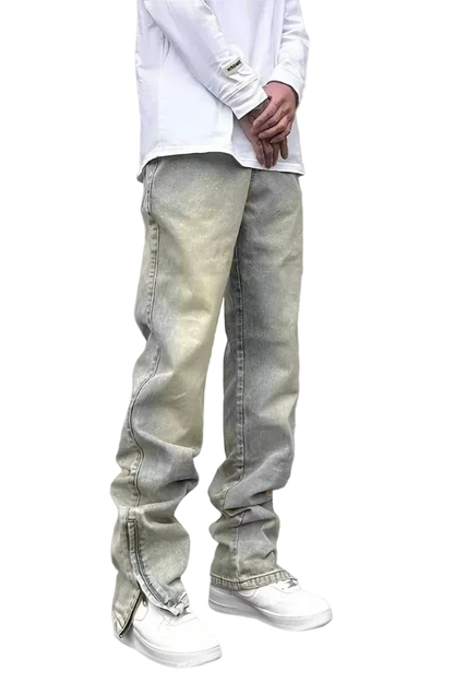Person wearing light-colored jeans and a white shirt on a gray background
