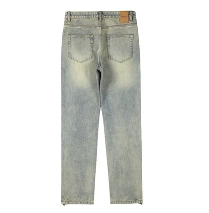 Back view of light-wash blue denim jeans with a faded yellowish tint, showing the back pockets and waistband on a white background.