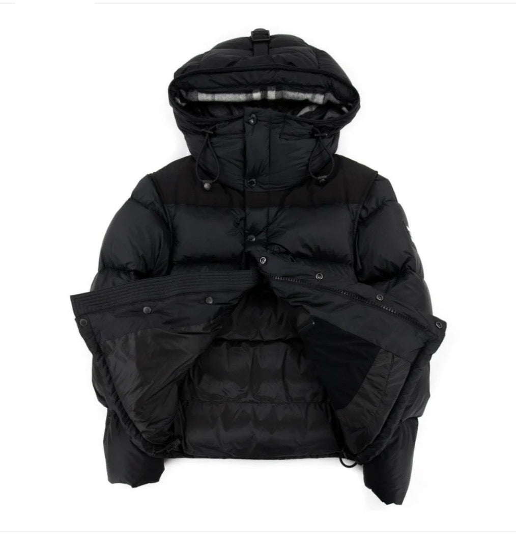 Black puffer jacket with hood on a white background, jacket half opened 