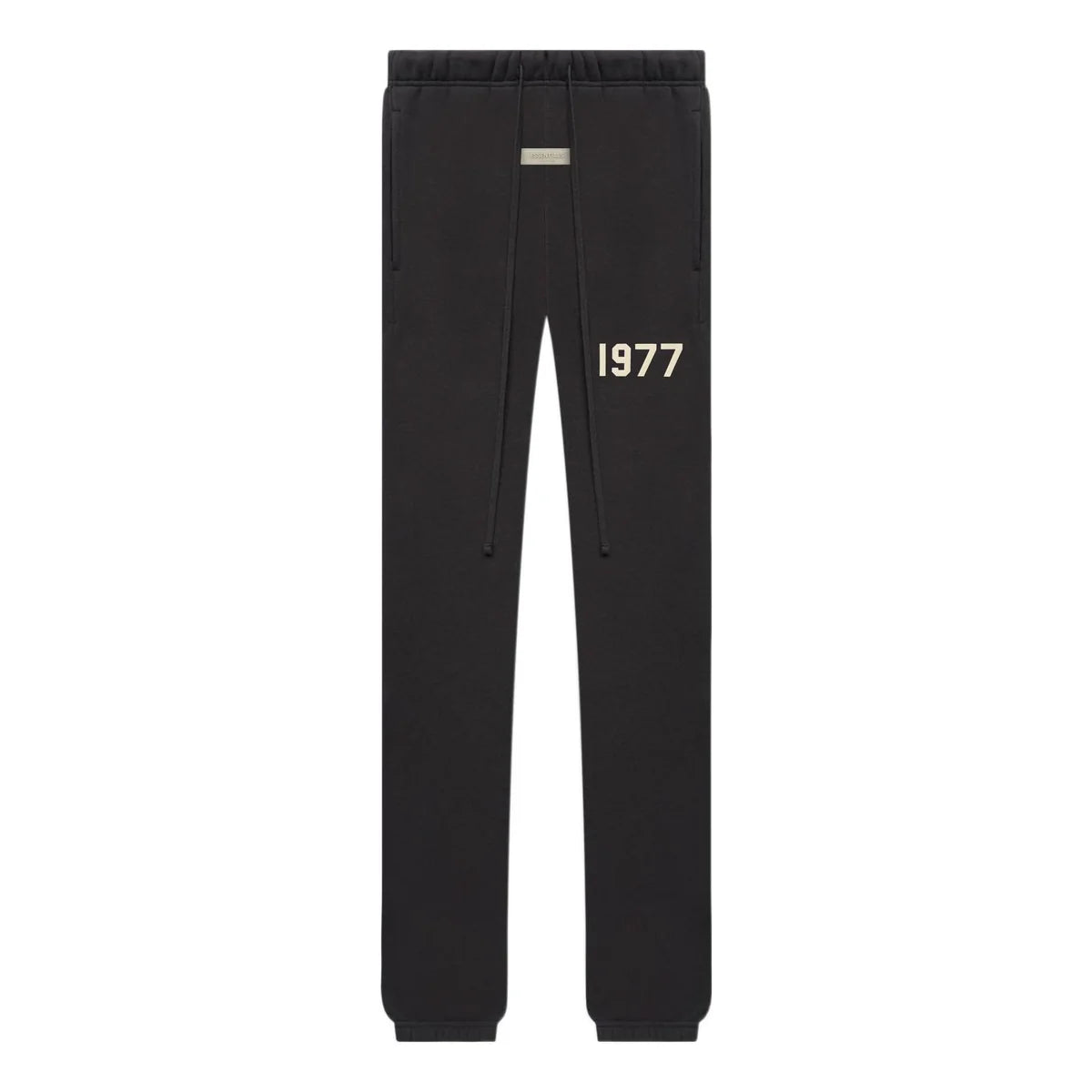 Black essentials sweatpants with '1977' printed on the front against a white background