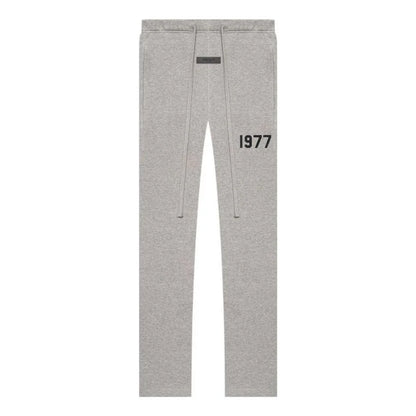 Gray essentials sweatpants with '1977' printed on a white background
