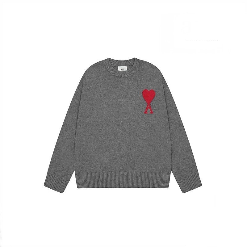 Gray AMI sweater with a red heart design on a white background