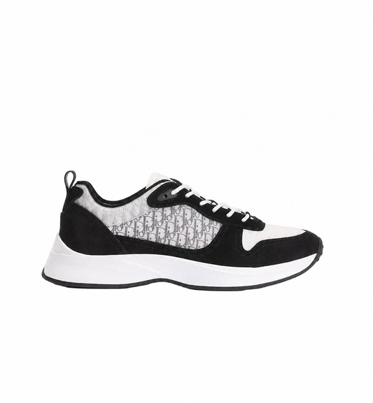 Black and white dior b25 sneaker shoes on a white background with Dior design in the side